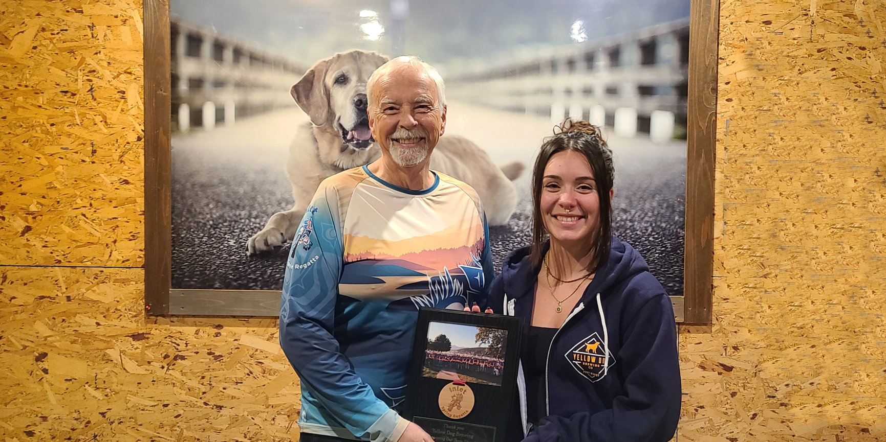 Brian Kenny, past president of Nothin’ Dragon and chairman of the Inlet Spring Regatta presents a plaque to tasting room manager, Jackie Blower on Nov. 20.